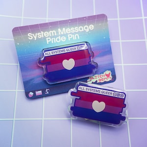 May include: A clear plastic pin with a bisexual pride flag design and the text "ALL SYSTEMS QUEER" in a pixelated font. The pin is on a white card with the text "System Message Pride Pin" and a logo that says "Glitch Berry".