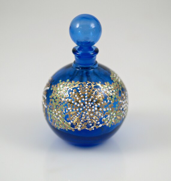 Cobalt BLue Glass Perfume Bottle with A circular glass scent bottle with a