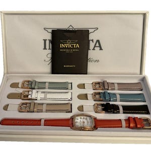 May include: A watch set in a white box. The set includes a rose gold watch with a red leather strap and multiple interchangeable straps in various colors like blue, white, and black. A black warranty card is also included.