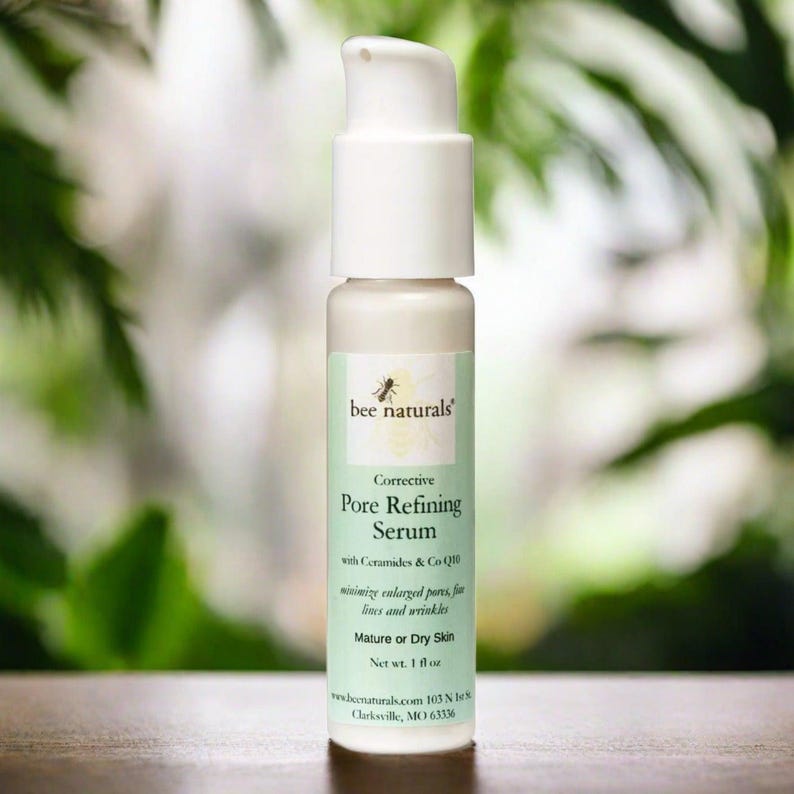 May include: A white bottle of bee naturals Corrective Pore Refining Serum with Ceramides & Co Q10. The bottle is labeled for mature or dry skin and has a net weight of 1 fl oz.