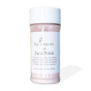 May include: A white jar with a pink label that says "bee naturals" and "Soft Facial Polish". The jar contains a pink facial polish. The label also says "Treat yourself like royalty with Bee Naturals Queen Bee Facial Polish. Our delicate mixture of oatmeal, lavender and 1 gentle exfoliating clay will brighten and refine your complexion. Net contents 2 fl. Oz. (60ml)"