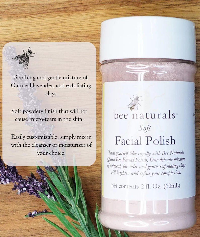May include: A white jar with a pink lid and a pink label that says "bee naturals Soft Facial Polish". The label also says "Treat yourself like royalty with Bee Naturals Queen Bee Facial Polish. Our delicate mixture of oatmeal, lavender and gentle exfoliating clays will brighten and refine your complexion. net contents 2 fl. Oz. (60mL)"