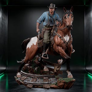 May include: A detailed statue of a cowboy on horseback. The cowboy wears a blue shirt, hat, and holds a gun. The horse is brown and white. The base features a miniature landscape with a "Wanted" sign and railroad tracks.