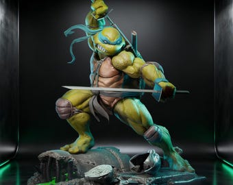May include: A detailed statue of Leonardo, a Teenage Mutant Ninja Turtle, in a dynamic fighting pose. The figure is predominantly green and brown, holding two katanas. The statue is set on a detailed base with a metallic helmet and green liquid.