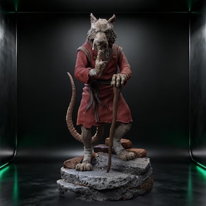 May include: A detailed statue of a rat-like humanoid figure in a red robe, holding a wooden staff and gesturing with a finger to the lips. The figure stands on a rocky base, with a long tail extending behind it.