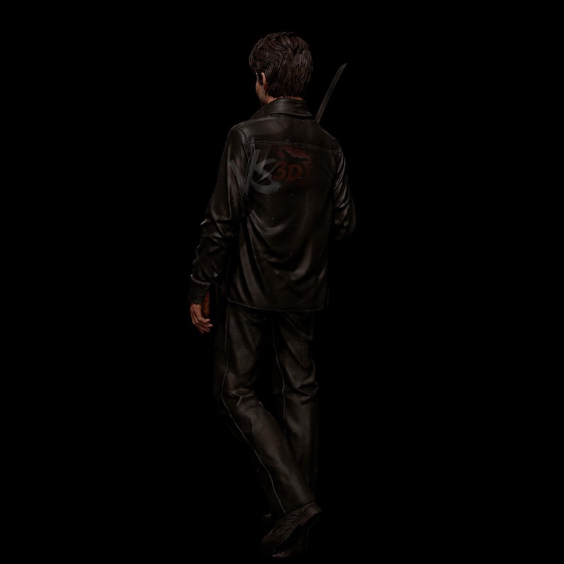 May include: A person wearing a black leather jacket and pants, holding a sword. The jacket has a red graphic on the back. The person is facing away from the camera against a black background.