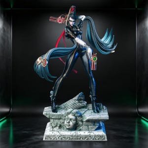May include: A detailed figurine of a character in a black bodysuit with long, flowing blue hair. The figure is posed dynamically, holding two guns, and stands on a stone base with a sculpted face.