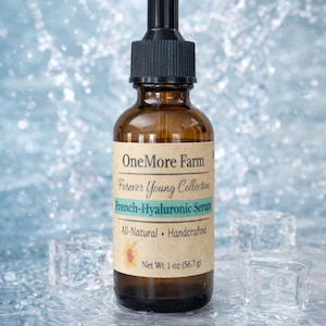 May include: A brown glass bottle of French-Hyaluronic Serum from OneMore Farm, with a black dropper top. The label reads "All-Natural, Handcrafted" and the net weight is 1 oz (56.7 g). The bottle is surrounded by ice cubes and water.