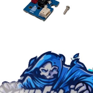 May include: A blue circuit board with a red switch labeled "ON" and a white toggle switch. A small screw is next to the board. Below is a blue and white graphic with a skull and the text "GAMER GHOSTS".