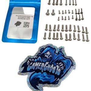 May include: A GameCube screw kit with various sizes of silver screws, a blue pouch with text, and a Gamerghosts sticker featuring a blue skull-faced figure.