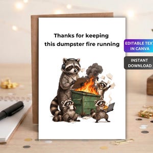 May include: A white greeting card featuring a cartoon illustration of four raccoons around a green dumpster on fire. The text reads, "Thanks for keeping this dumpster fire running." One raccoon wears headphones and holds a clipboard, while others hold papers.