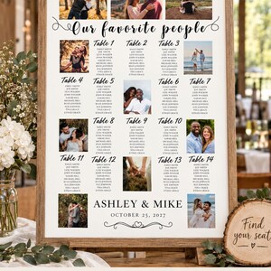 May include: A wedding seating chart sign in a wooden frame featuring the text Our favorite people, Ashley & Mike, October 25, 2027, and a grid of 14 tables with guest names and small photographs of couples in various outdoor settings.