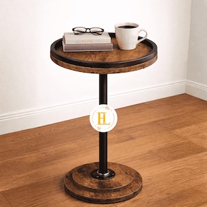 May include: A round side table with a dark brown wooden top and base, supported by a black metal pole. The table has a raised edge and is holding a stack of books, a pair of glasses, and a coffee mug. The table is 24 inches tall.