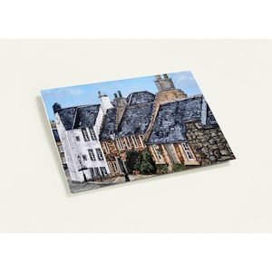 May include: A painting of a street scene featuring several buildings with dark blue slate roofs and stone walls. The buildings are painted in shades of white, brown, and gray, with a clear blue sky in the background. The artwork is on a white background.