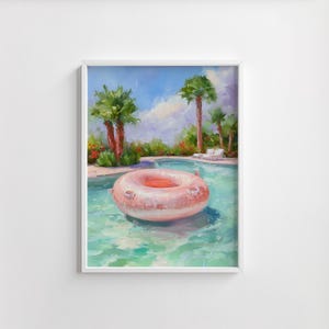 May include: A framed painting depicts a serene pool scene. A light pink inflatable ring floats in the turquoise water. Palm trees and lush greenery surround the pool under a blue sky with fluffy clouds. The artwork evokes a sense of relaxation.