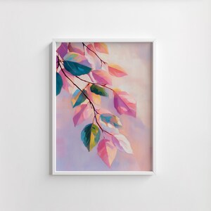 May include: A framed art print featuring a branch with colorful leaves. The leaves display shades of pink, teal, green, and yellow, set against a soft, pastel background. The artwork is encased in a white frame, suitable for home decor.