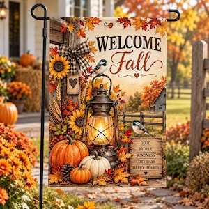 May include: A rectangular garden flag featuring the text WELCOME Fall, a lit rustic lantern, pumpkins, sunflowers, and two birds. The design includes a wooden sign with the words GOOD PEOPLE KINDNESS COZY DAYS HAPPY HEARTS, surrounded by autumn leaves.