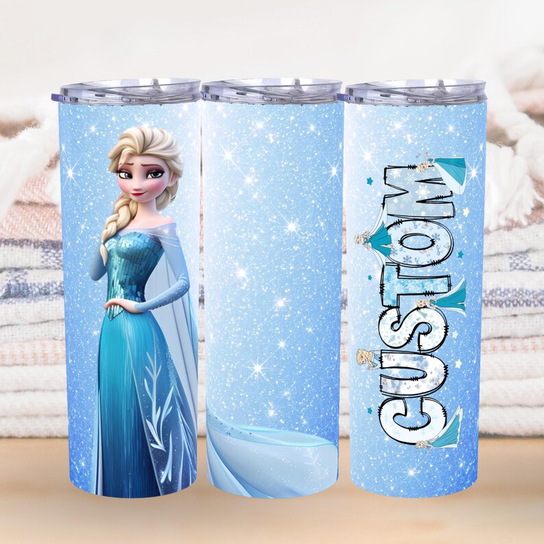 May include: A custom tumbler featuring a cartoon image of a princess in a blue dress with a cape. The tumbler has a light blue background with glitter and the word "CUSTOM" in a stylized font.