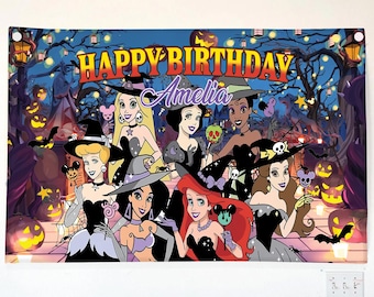 May include: A rectangular banner featuring a Halloween-themed illustration of seven animated princesses wearing witch hats and costumes. The text "HAPPY BIRTHDAY" appears in yellow at the top, with the name "Amelia" written in purple script below.