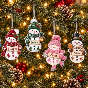 May include: Six hanging snowman ornaments with personalized name plaques reading Amelia, Harper, Evelyn, Liam, Ethan, and Lucas. Each snowman features unique winter accessories like hats, scarves, and earmuffs in blue, red, green, pink, black, and purple.