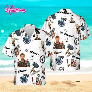 May include: White button-down shirt featuring a repeating pattern of Thor characters, hammers, and the word "Thor". The shirt has short sleeves and a classic collar. The background shows a beach scene.