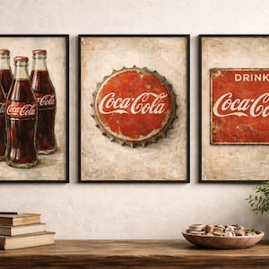 May include: Set of three framed Coca-Cola art prints. One print features four bottles, another a bottle cap, and the third a vintage sign with the words "Drink Coca-Cola". The prints have a vintage, distressed look.