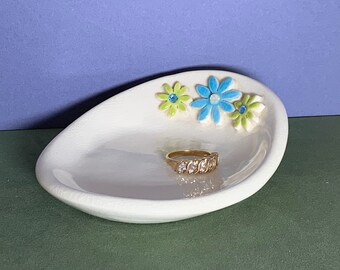 Turquoise and bright green daisies with lovely crystals on white oval dish. Use to hold rings, kitchen sponge, keys and more