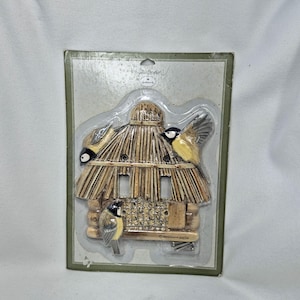 May include: A decorative light switch plate featuring a three-dimensional log cabin design with a thatched roof and three small birds. The item is sealed in original packaging with the text Marjolein Bastin by Hallmark visible.
