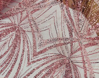 May include: A sheer pink mesh fabric featuring an intricate geometric pattern of diamonds and curved lines. The design is heavily embellished with small, shimmering pink sequins that follow the linear motifs, creating a textured surface.