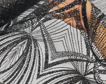 May include: A sheer black mesh fabric featuring an intricate geometric pattern of black sequins and beads. The design consists of repeating diamond shapes and radiating lines, with the sequins densely applied to create a textured, shimmering surface.