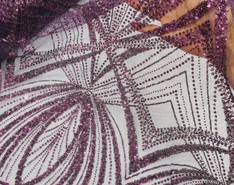 May include: A sheer purple fabric featuring an intricate geometric pattern composed of dense, shimmering sequins. The design includes repeating diamond and fan-like shapes outlined with rows of small, reflective purple sequins on a fine mesh base.