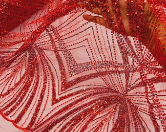 May include: A vibrant red fabric featuring an intricate pattern of dense sequins and beads arranged in geometric diamond and fan-like shapes. The material is a sheer, lightweight mesh base that highlights the detailed, shimmering red embroidery.