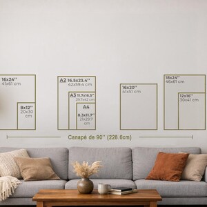 May include: A living room scene with a gray sofa, wooden coffee table, and a floor lamp. The wall displays framed art prints in various sizes, including 16x24" (41x61 cm), 8x12" (20x30 cm), and others, with measurements in inches and centimeters.