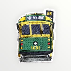 May include: Embroidered patch featuring a green and yellow Melbourne tram. The patch has the word "MELBOURNE" above the windows and the number "35" on a flag. The tram's number "1031" is displayed on the front.