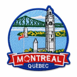 May include: A circular embroidered patch featuring a scene of Montreal, Quebec, with a white clock tower, a green bridge, a blue river, and a Canadian flag. A red banner at the bottom displays the white text MONTREAL and the word QUEBEC below it.