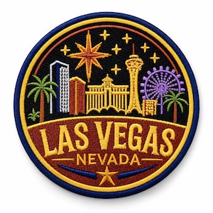 May include: A circular embroidered patch featuring a Las Vegas skyline at night. The design includes palm trees, buildings, a tower, and a purple Ferris wheel under yellow stars. The text LAS VEGAS NEVADA is stitched in yellow on a dark red background.
