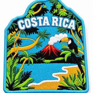 May include: An embroidered patch featuring a tropical landscape with the text COSTA RICA in white. The design includes a smoking volcano, a toucan perched on a palm tree, lush green foliage, a blue body of water, and a sandy beach with a blue border.