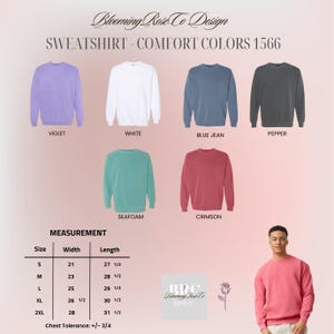 May include: A display of sweatshirts in various colors, including violet, white, blue jean, pepper, seafoam, and crimson. The image includes a size chart with measurements in inches and the text "SWEATSHIRT - COMFORT COLORS 1566".