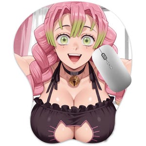 May include: A pink and green anime character mouse mat with a white computer mouse. The mat features a smiling character with pink hair, green highlights, and a black outfit. The mouse is white with a scroll wheel.