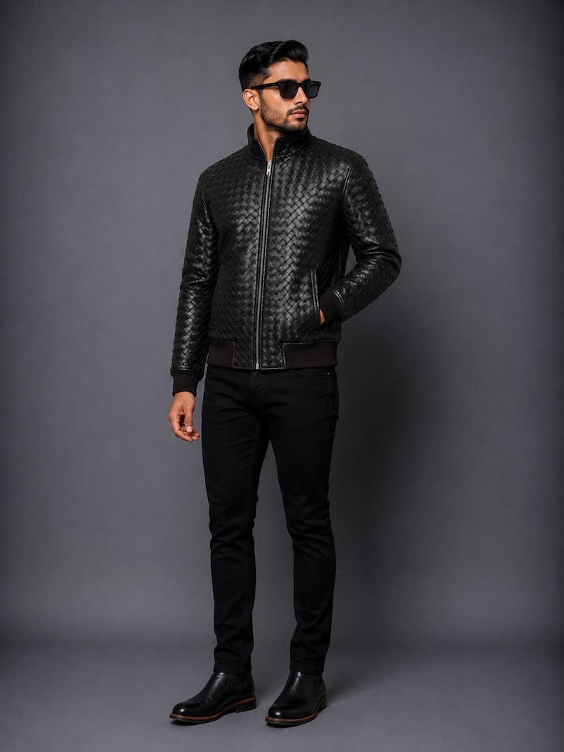 Black leather bomber coat with detailed woven texture and classic fit