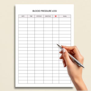 May include: A white sheet of paper with the words "BLOOD PRESSURE LOG" at the top. The paper has a grid with columns labeled "DATE", "TIME", "SYSTOUC", "DIASTOUC", a heart symbol, and "Notes". A hand holds a pen over the paper.