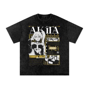 May include: Black graphic t-shirt featuring anime-style artwork with the word "AKITA" in large white letters. The design includes a character illustration and the text "TSUNDERE QUEEN" in yellow.