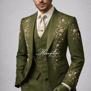 May include: Olive green three-piece suit with floral embroidery and pearl accents. The suit includes a jacket, vest, and trousers, paired with a cream-colored tie and gloves. The Hampton Studio Inc. logo is visible.