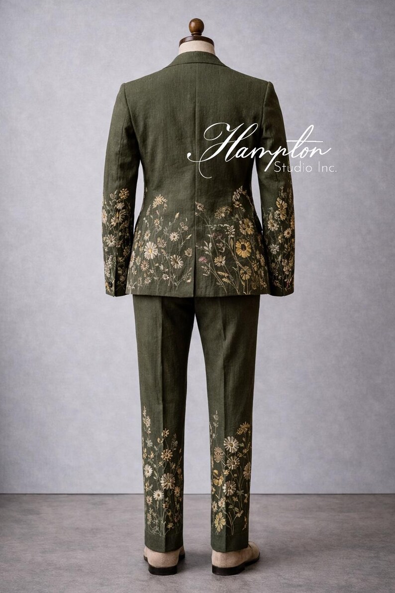 May include: Olive green suit with floral embroidery. The jacket and pants feature detailed embroidery of wildflowers in shades of yellow, cream, and brown. The suit is displayed on a mannequin. The text "Hampton Studio Inc." is visible.