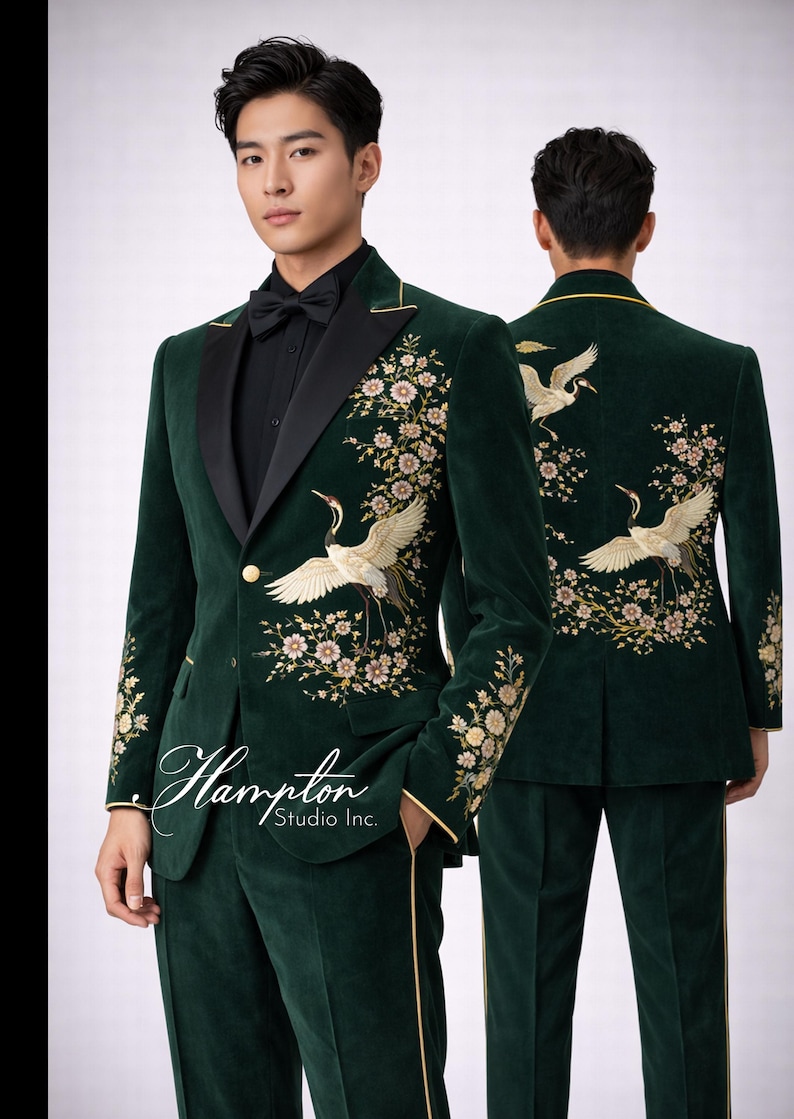 May include: Emerald green velvet suit with floral and crane embroidery. The suit features a black satin lapel, gold trim, and a single-button closure. The image includes the text "Hampton Studio Inc."