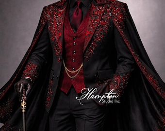 May include: A black suit with a red vest, tie, and cape, featuring ornate red embroidery. The suit includes a gold chain and is paired with black gloves and a cane. The image is from Hampton Studio Inc.