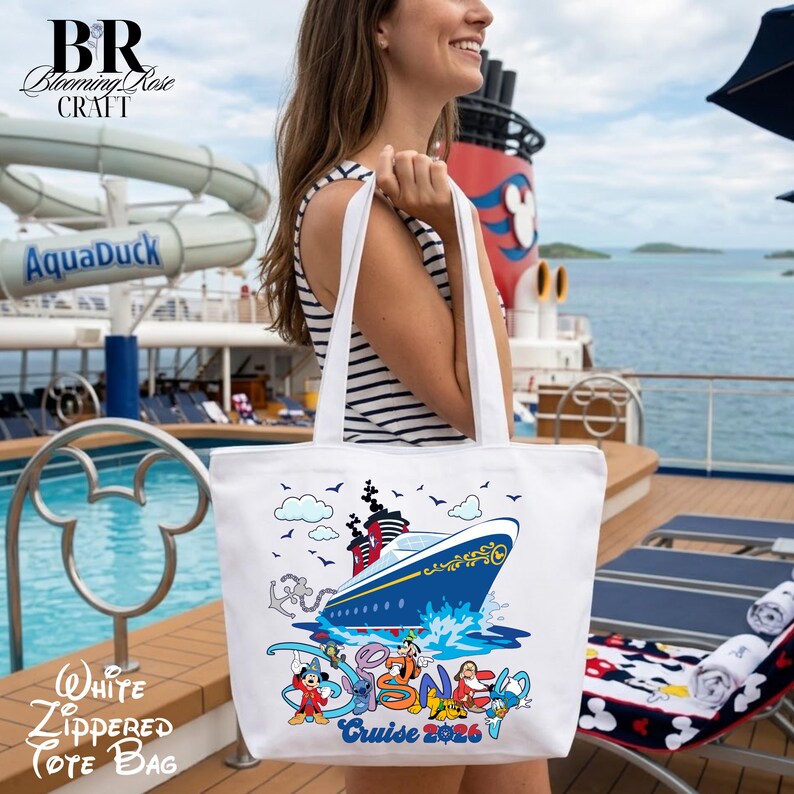 May include: A white tote bag featuring a colorful graphic of a cruise ship sailing on blue water, surrounded by various cartoon characters. The design includes the text Cruise 2026 at the bottom. The bag has two white shoulder straps.