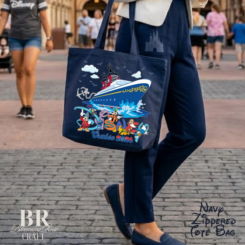 May include: A navy blue tote bag featuring a graphic of a cruise ship, white clouds, and various cartoon characters. The text "Disney Cruise 2026" is printed in blue and red. The bag has two shoulder straps and a large main compartment for storage.
