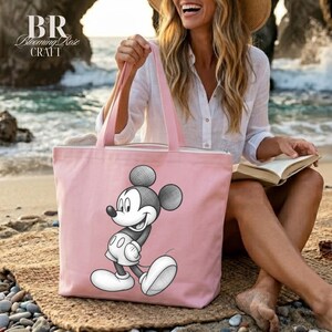 May include: A light pink tote bag featuring a black and white illustration of Mickey Mouse. The bag has pink handles and the text "BR Blooming Rose Craft" in the upper left corner. The bag is made of a canvas-like material.