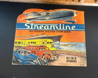 May include: Vintage "Streamline" picture story book cover. The cover features illustrations of an airship, airplanes, a ship, a train, and cars. The title "Streamline" is in blue and white, with the text "The Modern Picture Story Book".